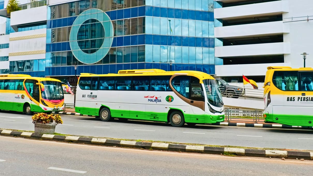 INSAR coaches waiting in line on the riverside in central Kuching