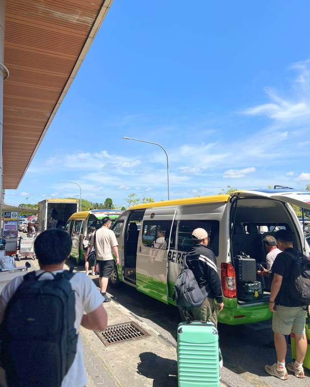 Travellers loading luggage into INSAR tour vans on an airport transfer