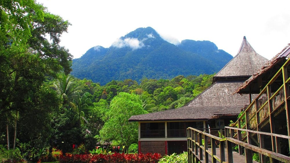 Traditional Sarawak longhouse architecture below the forested slopes of Mount Santubong
